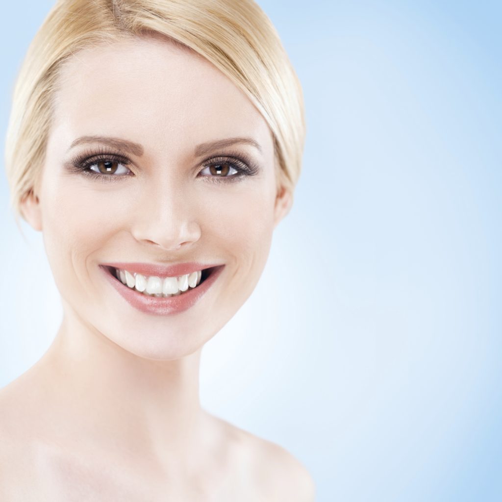 blonde woman smiling showing how smiling can enhance your life