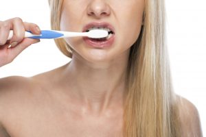 woman brushing teeth