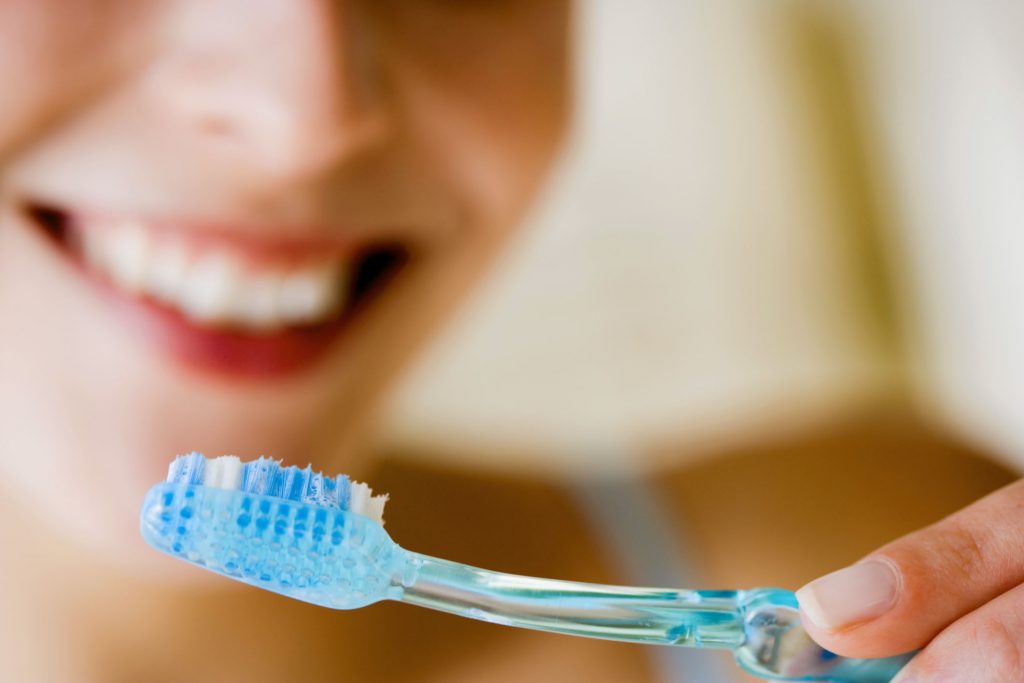 how to properly brush your teeth, woman with toothbrush