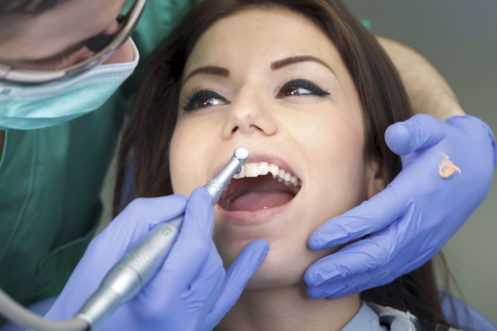 woman in dental chair starting the year off with an oral cancer screening