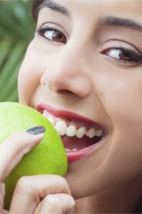 woman biting apple