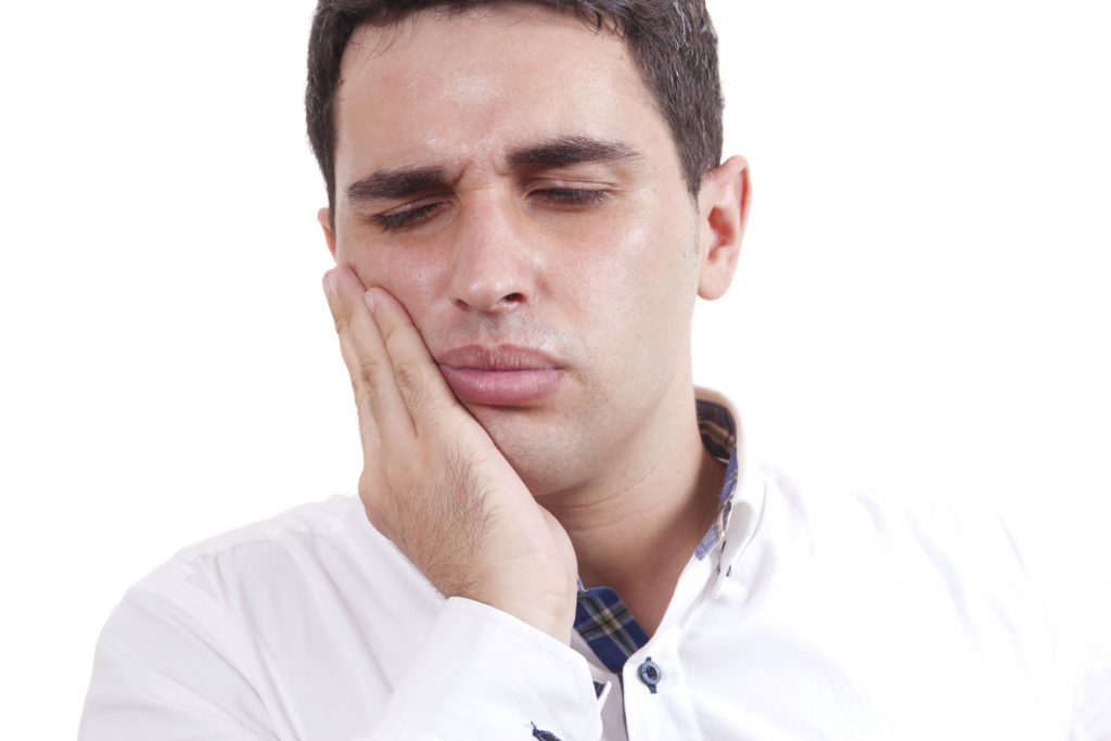 man suffering from sensitive teeth