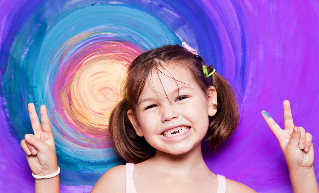 little girl smiling and why it's critical to care for baby teeth and how to do it
